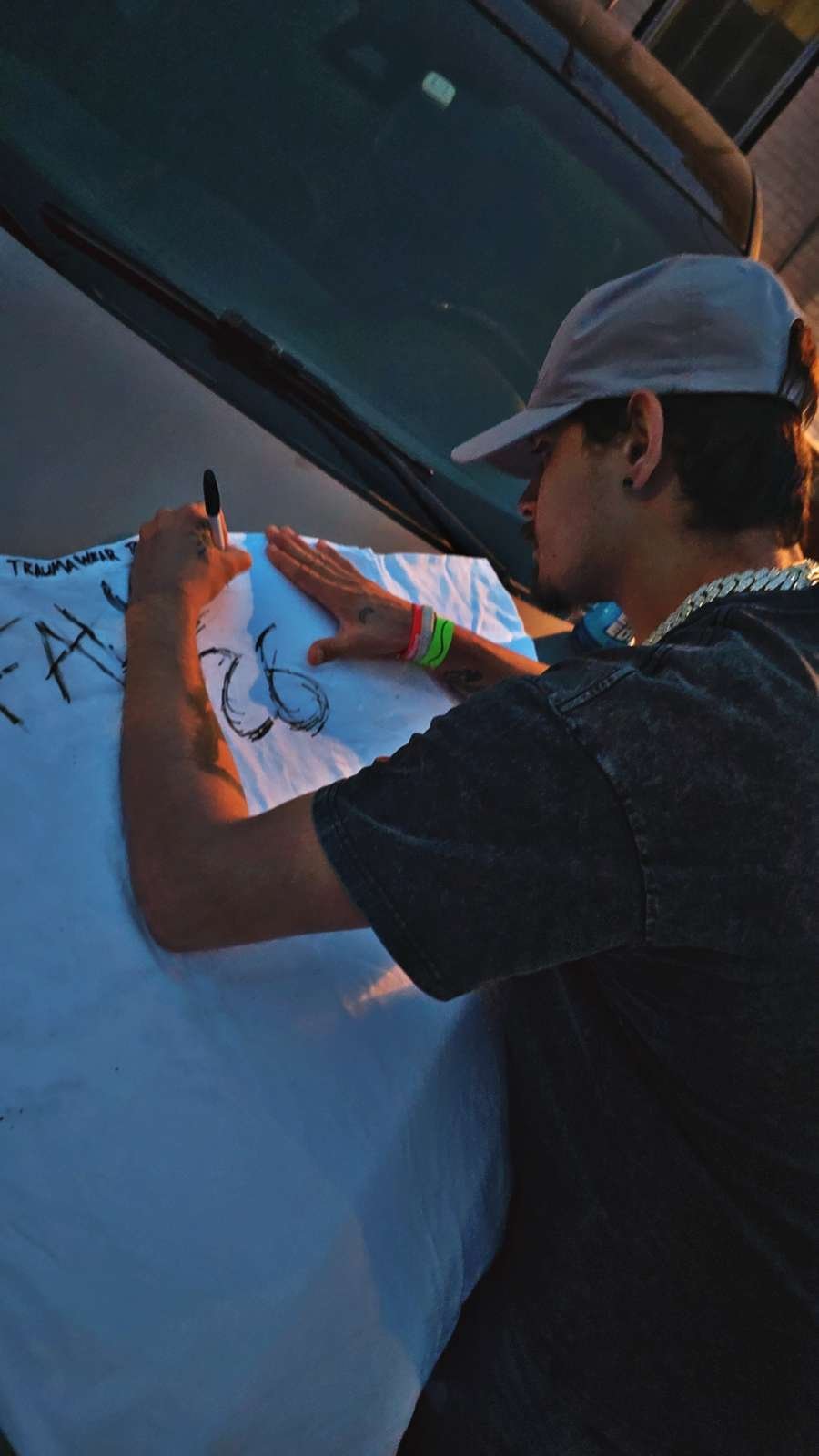 Zach signing a shirt banner